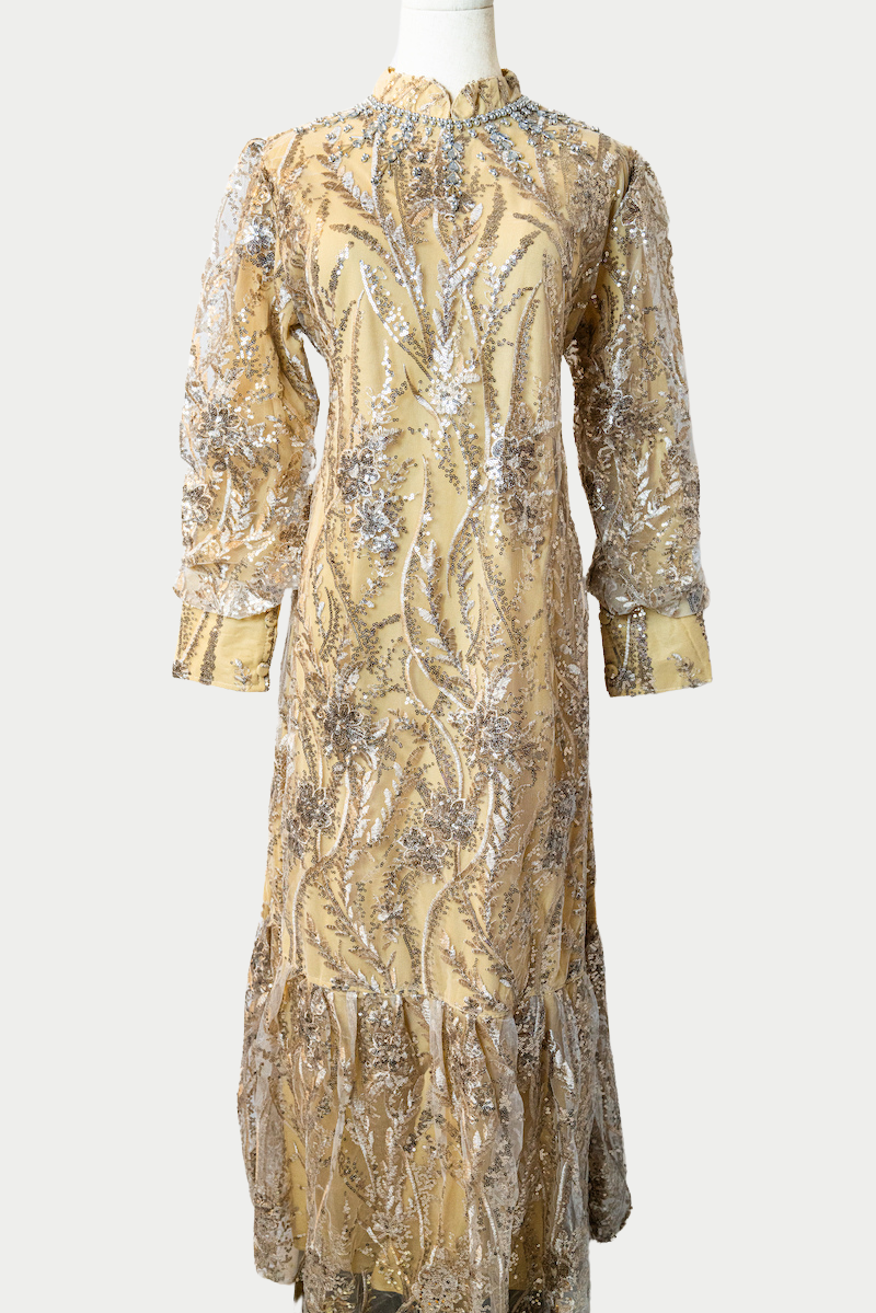 A stunning long dress in yellow with sequins and delicate embroidery. The dress has mandarin collar, banded cuffs, long sleeves, and is fully lined. There are hidden zips at the back and sleeves for ease of wear. The design is hijabi-friendly for modesty and style. It also includes a size-adjustable belt for a customized fit.